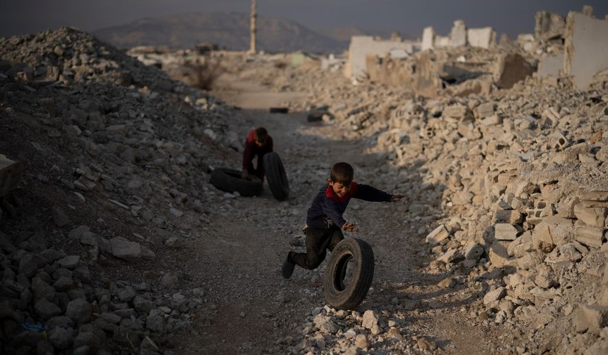 Kids play surrounded by rubble on an area of houses that were completely destroyed during the civil war at the Al-Asali neighbourhood in Damascus, Syria, Jan. 6, 2025. (AP Photo/Leo Correa) **FILE**