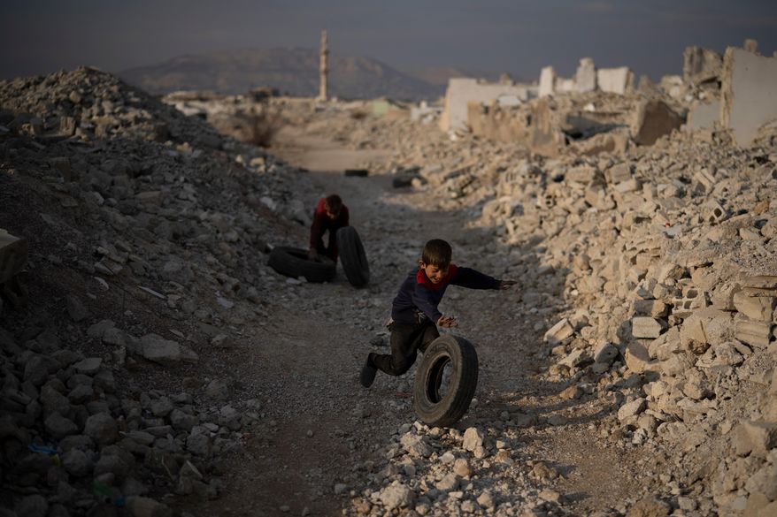 Kids play surrounded by rubble on an area of houses that were completely destroyed during the civil war at the Al-Asali neighbourhood in Damascus, Syria, Jan. 6, 2025. (AP Photo/Leo Correa) **FILE**