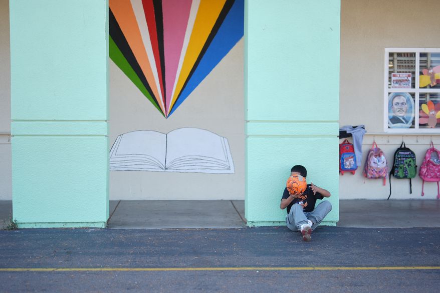 A student takes a break from soccer during recess, Nov. 13, 2025, in San Diego. (AP Photo/Gregory Bull)