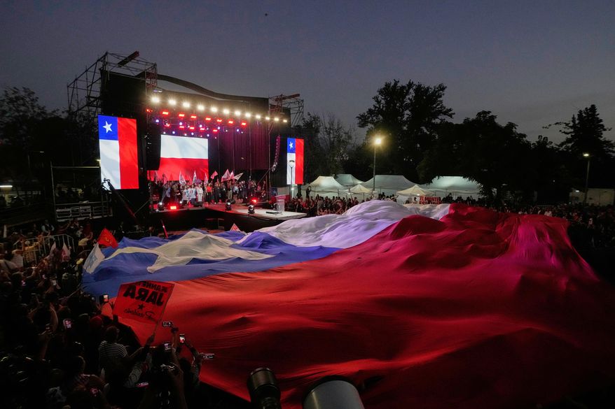 Supporters of Presidential candidate Jeannette Jara of the Unidad por Chile coalition attend a rally ahead of the presidential runoff election in Santiago, Chile, Wednesday, Dec. 10, 2025. (AP Photo/Esteban Felix)