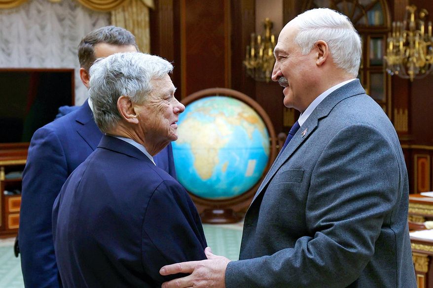 In this photo released by Belarusian presidential press service, Belarusian President Alexander Lukashenko, right, and President Trump's special envoy for Belarus John Coale shake hands during their meeting in Minsk, Belarus, Friday, Dec. 12, 2025. (Belarusian Presidential Press Service via AP)