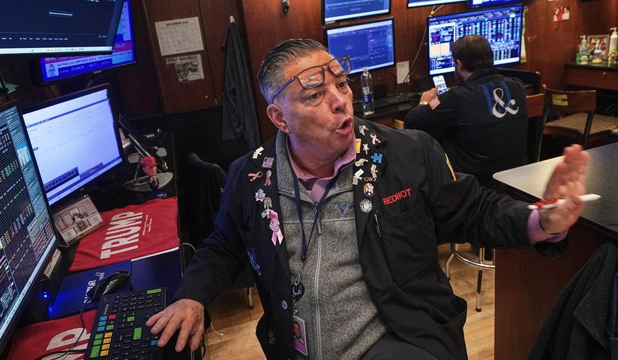 Trader Jonathan Mueller works on the floor of the New York Stock Exchange, Thursday, Dec. 11, 2025. (AP Photo/Richard Drew)