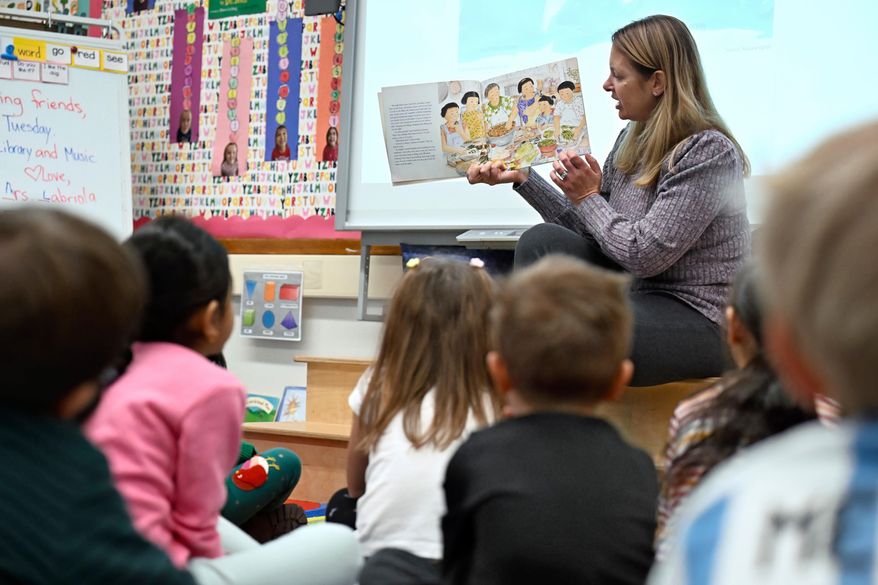 Kindergarten teacher Christin Labriola reads the book "Dumpling Soup" to her class, incorporating Asian American and Pacific Islander subjects in her class at Webster Hill Elementary School in West Hartford, Conn., on Dec. 2, 2025. (AP Photo/Jessica Hill)