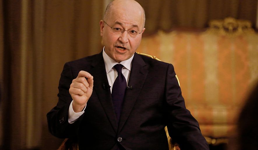 FILE - Iraq's President Barham Salih speaks during an interview with The Associated Press in Baghdad, Iraq, Friday, March 29, 2019. (AP Photo/Khalid Mohammed, File )