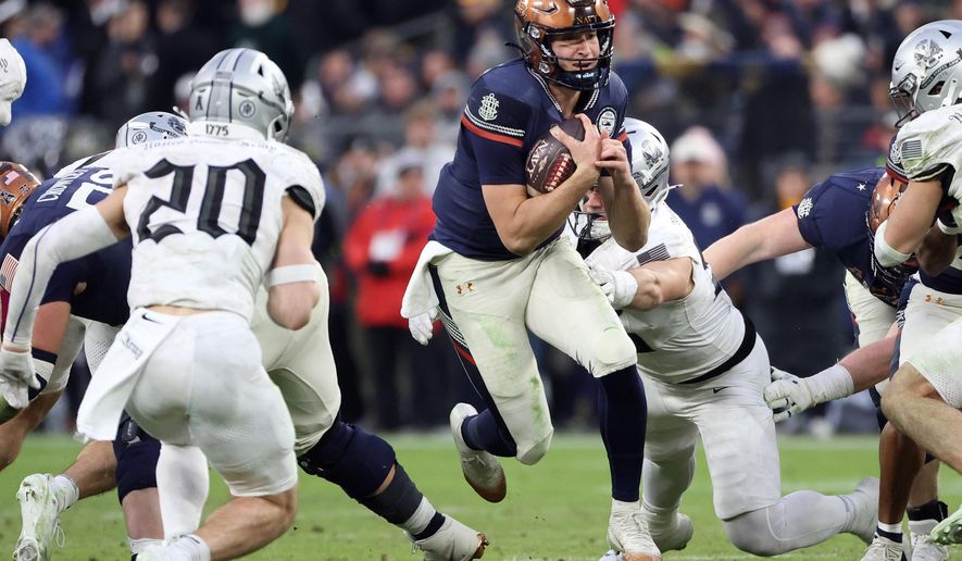 Navy quarterback Blake Horvath runs with the ball during the first half of an NCAA college football game against Army, Saturday, Dec. 13, 2025, in Baltimore. (AP Photo/Daniel Kucin Jr.)