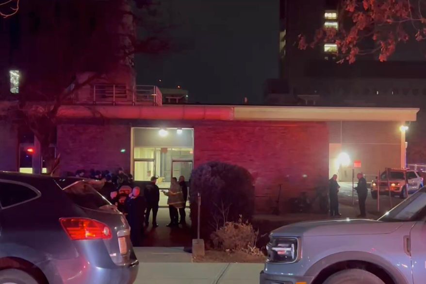 In this image from video, law enforcement officials gather outside the Brown University campus in Providence, R.I., on Saturday, Dec. 13, 2025. (AP Photo/Kimberlee Kruesi)