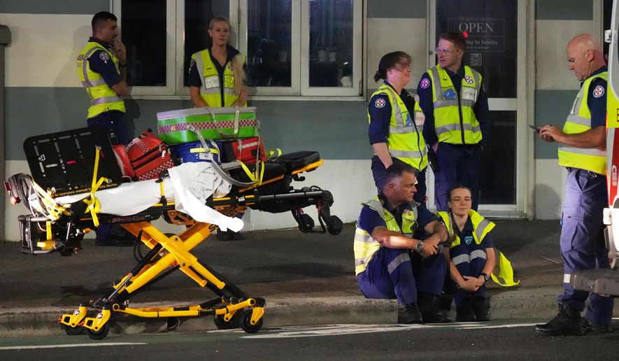Emergency workers standby at Bondi Beach after a reported shooting in Sydney, Sunday, Dec. 14, 2025. (AP Photo/Mark Baker)
