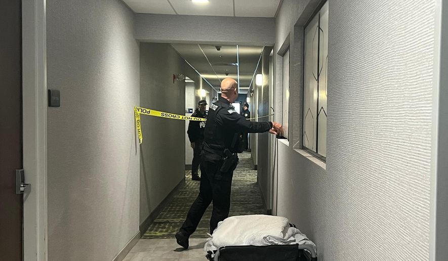 Police tape off hotel rooms where the person of interest was arrested in a shooting in Coventry, RI., (AP Photo/Kimberlee Kruesi)