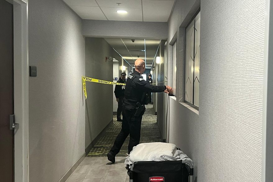 Police tape off hotel rooms where the person of interest was arrested in a shooting in Coventry, RI., (AP Photo/Kimberlee Kruesi)