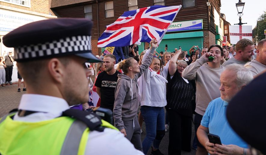 FILE - Protesters wave a Union Flag during a demonstration in Orpington near London, Friday, Aug. 22, 2025 as the dilemma of how to house asylum-seekers in Britain got more challenging for the government after a landmark court ruling this week motivated opponents to fight hotels used as accommodation. (AP Photo/Alberto Pezzali, File)