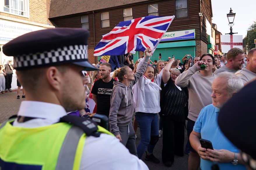 FILE - Protesters wave a Union Flag during a demonstration in Orpington near London, Friday, Aug. 22, 2025 as the dilemma of how to house asylum-seekers in Britain got more challenging for the government after a landmark court ruling this week motivated opponents to fight hotels used as accommodation. (AP Photo/Alberto Pezzali, File)