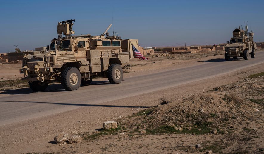 A U.S. military convoy drives along a road in northeastern Syria's Hasakeh province, Thursday, Jan. 30, 2025. (AP Photo/Bernat Armangue, File)
