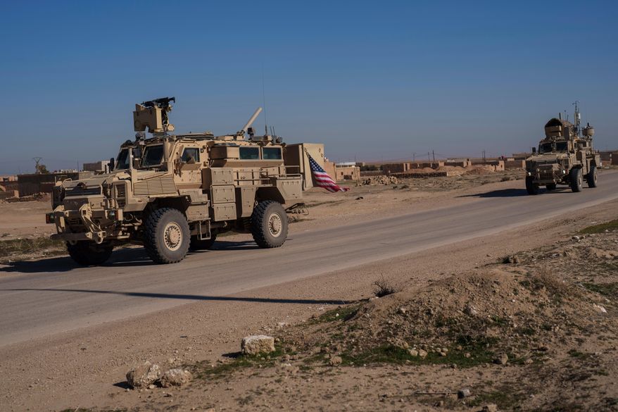 A U.S. military convoy drives along a road in northeastern Syria's Hasakeh province, Thursday, Jan. 30, 2025. (AP Photo/Bernat Armangue, File)