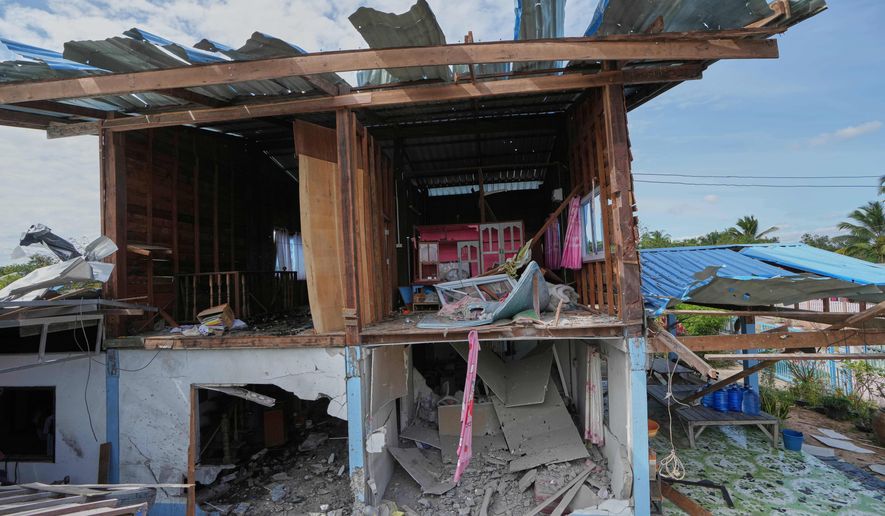 A house is seen damaged following a Thai soldier said was a Cambodian artillery strike in Sisaket province, Thailand, Sunday, Dec. 14, 2025. (AP Photo/Sakchai Lalit)