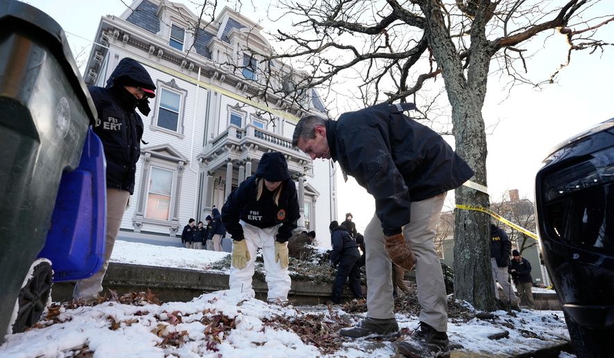 Members of the FBI Evidence Response Team search for evidence near the campus of Brown University, Monday, Dec. 15, 2025, in Providence, R.I. (AP Photo/Robert F. Bukaty)