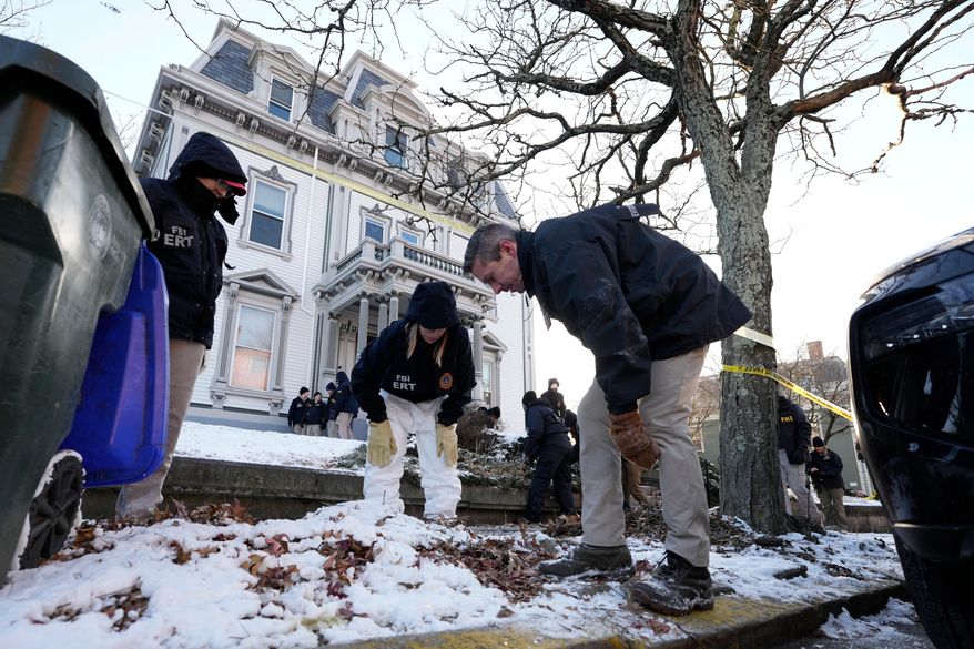 Members of the FBI Evidence Response Team search for evidence near the campus of Brown University, Monday, Dec. 15, 2025, in Providence, R.I. (AP Photo/Robert F. Bukaty)