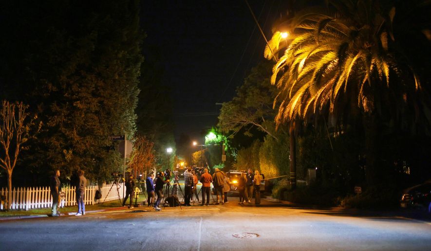 News media gather near Rob Reiner's residence Sunday, Dec. 14, 2025, in the Brentwood section of Los Angeles. (AP Photo/Ethan Swope)