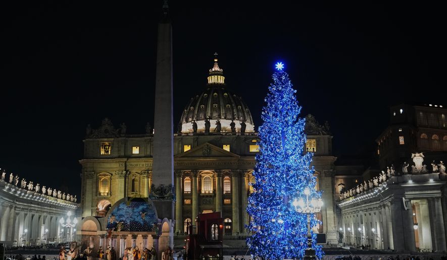 A 27-meter fir tree from the Ultimo valley in South Tyrol, Italy, is lit up as Christmas tree together with a crib in St. Peter's Square at the Vatican, Monday, Dec. 15, 2025. (AP Photo/Alessandra Tarantino)
