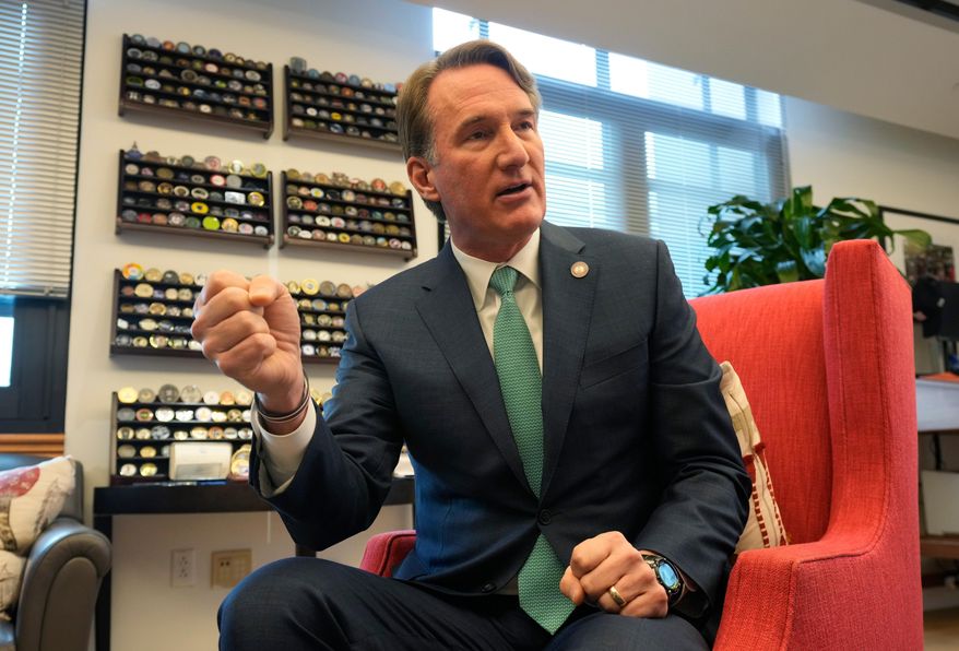 Virginia Gov. Glenn Youngkin gestures during an interview in his office at the Capitol Wednesday Dec. 10, 2025, in Richmond, Va. (AP Photo/Steve Helber)