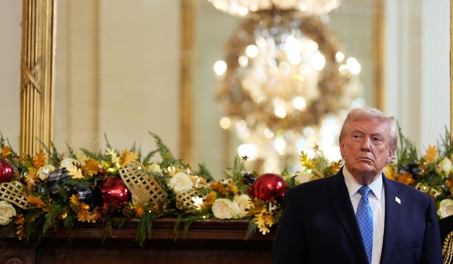 President Donald Trump listens as Rabbi Levi Shemtov speaks during a Hanukkah reception in the East Room of the White House, Tuesday, Dec. 16, 2025, in Washington. (AP Photo/Alex Brandon)