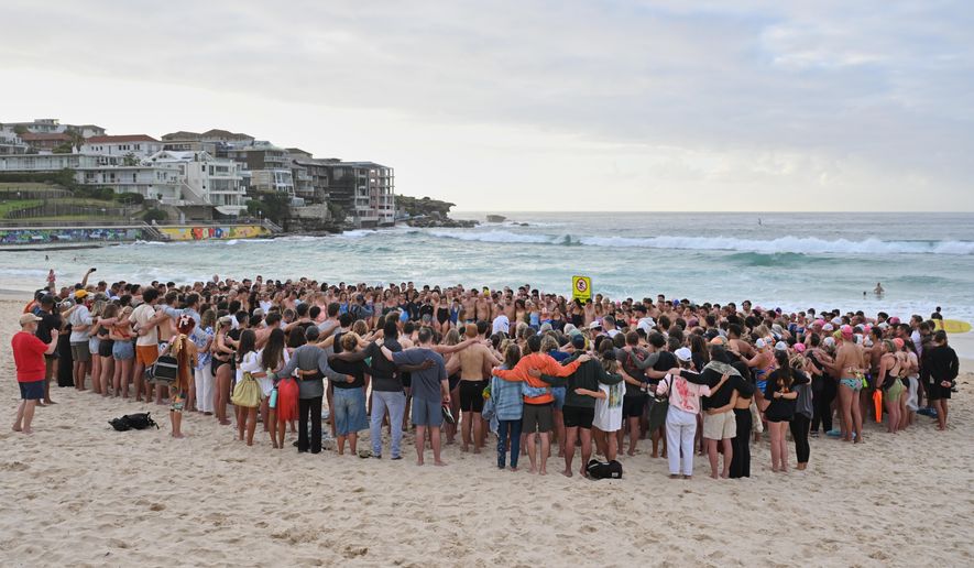 Swimmers gather for a morning vigil in Sydney, Wednesday, Dec. 17, 2025, following Sunday's shooting at Bondi Beach. (Mick Tsikas/AAP Image via AP)/AAP Image via AP)