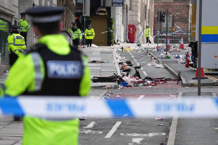 FILE - Police guards the site where a 53-year-old British man plowed a minivan into a crowd of Liverpool soccer fans who were celebrating the city's Premier League championship Monday, injuring more than 45 people in Liverpool, England, Tuesday, May 27, 2025.(AP Photo/Jon Super, File)