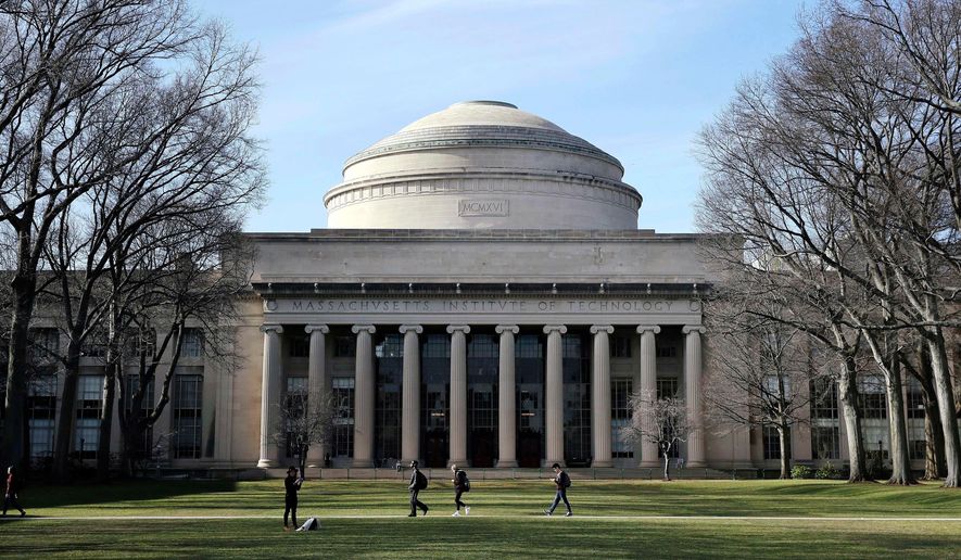 Students walk past the "Great Dome" atop Building 10 on the Massachusetts Institute of Technology campus in Cambridge, Mass., April 3, 2017. (AP Photo/Charles Krupa, File)