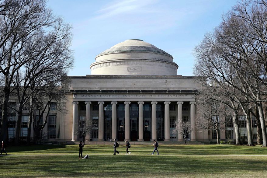 Students walk past the "Great Dome" atop Building 10 on the Massachusetts Institute of Technology campus in Cambridge, Mass., April 3, 2017. (AP Photo/Charles Krupa, File)