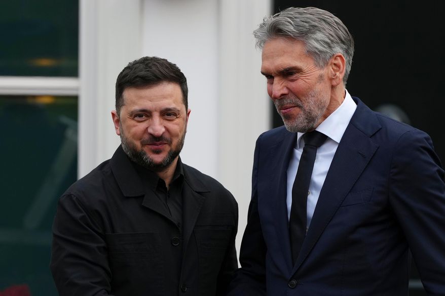 Dutch Prime Minister Dick Schoof, right, welcomes Ukraine's President Volodymyr Zelenskyy in The Hague, Netherlands, Tuesday, Dec. 16, 2025. (AP Photo/Peter Dejong)