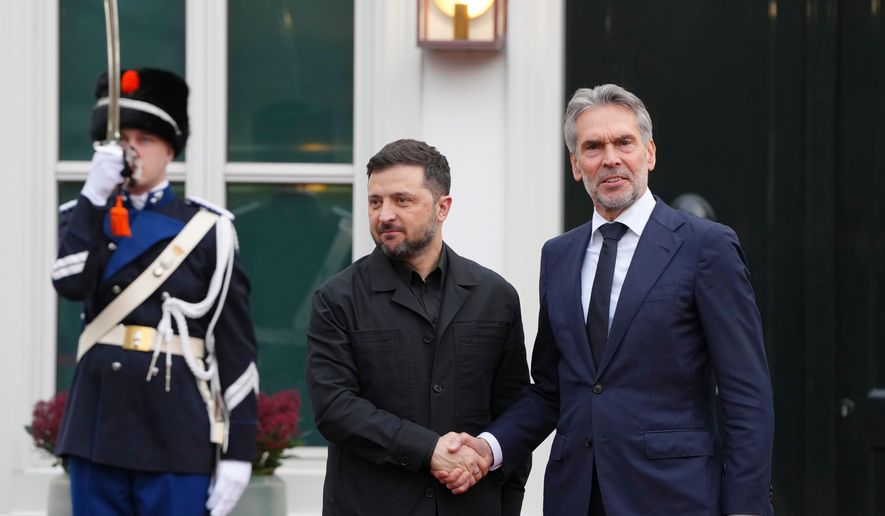 Dutch Prime Minister Dick Schoof, right, welcomes Ukraine's President Volodymyr Zelenskyy in The Hague, Netherlands, Tuesday, Dec. 16, 2025. (AP Photo/Peter Dejong)