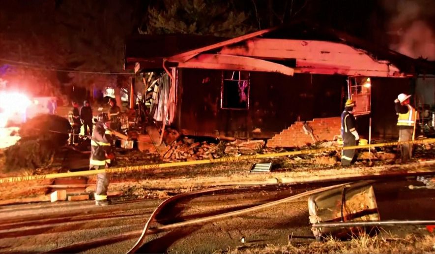 Firefighters look over the scene of a house fire explosion late Monday, Dec. 15, 2025 in Salisbury, N.C. (WSOC via AP)