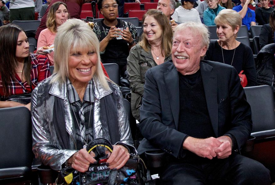 Phil Knight, right, and Penny Knight, watch the first half of an NCAA college basketball game in the Phil Knight Invitational tournament in Portland, Ore., Nov. 26, 2017. (AP Photo/Craig Mitchelldyer, File)