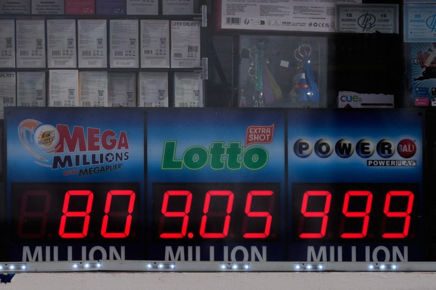 Jackpot payouts for the Mega Millions, Lotto, and Powerball are seen in a convenience store window in Prospect Height, Ill., Monday, Dec. 15, 2025. (AP Photo/Nam Y. Huh)