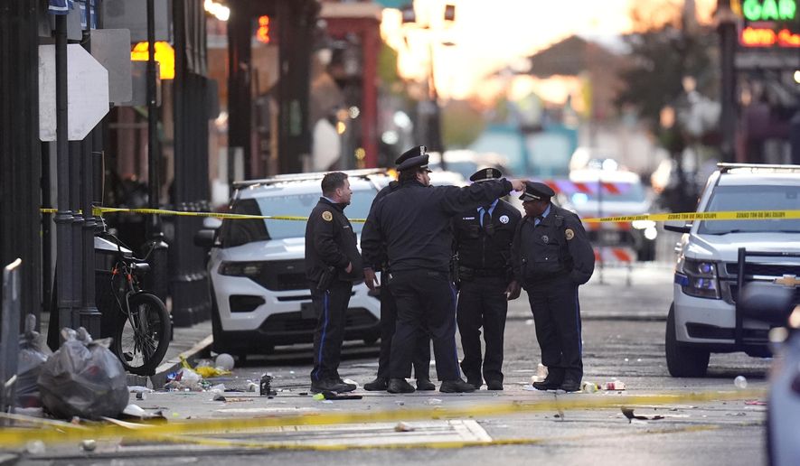 FILE - Security personnel gather at the scene on Bourbon Street after a vehicle drove into a crowd in New Orleans, Jan. 1, 2025. (AP Photo/Gerald Herbert, File)
