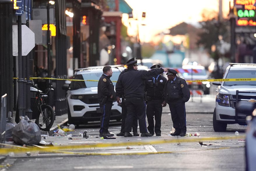 FILE - Security personnel gather at the scene on Bourbon Street after a vehicle drove into a crowd in New Orleans, Jan. 1, 2025. (AP Photo/Gerald Herbert, File)