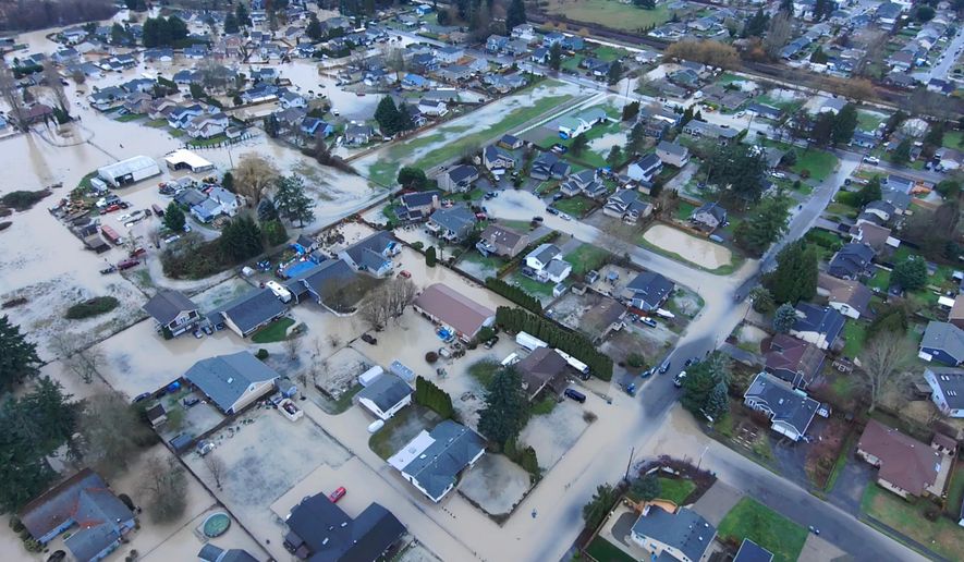 This image made from a video provided by the Pacific Police Department shows homes underwater, Tuesday, Dec. 16, 2025, in Pacific, Wash. (Pacific Police Department via AP)