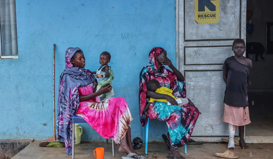 Patients sit outside the malnutrition ward of Bunj Hospital in Maban, South Sudan, Aug. 19, 2025. (AP Photo/Caitlin Kelly, File)