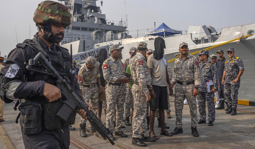 A police officer stands guard as Mumbai Police takes charge of the accused Somali pirates brought by the Indian navy on its warship INS Kolkata at Naval Dockyard in Mumbai, India, Saturday, March 23, 2024. The Indian navy had said last Saturday that it had taken control of the hijacked Maltese-flagged MV Ruen bulk carrier and that all 35 pirates on board had surrendered. (AP Photo/Rafiq Maqbool) **FILE**