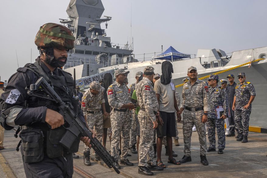 A police officer stands guard as Mumbai Police takes charge of the accused Somali pirates brought by the Indian navy on its warship INS Kolkata at Naval Dockyard in Mumbai, India, Saturday, March 23, 2024. The Indian navy had said last Saturday that it had taken control of the hijacked Maltese-flagged MV Ruen bulk carrier and that all 35 pirates on board had surrendered. (AP Photo/Rafiq Maqbool) **FILE**