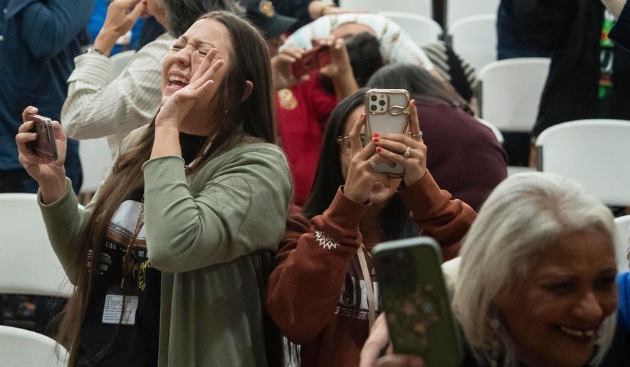 People celebrate after passage of the National Defense Authorization Act by the U.S. Senate, during a watch party hosted by the Lumbee Tribe of North Carolina, Wednesday, Dec. 17, 2025, in Pembroke, N.C. (AP Photo/Allison Joyce)