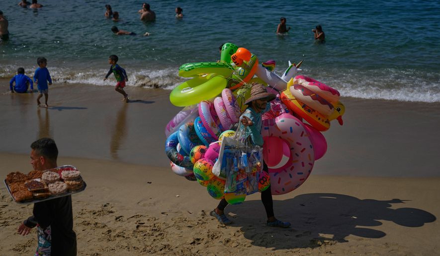 A vendor sells inflatables on Macuto beach in Venezuela, Wednesday, Dec. 17, 2025. (AP Photo/Ariana Cubillos)