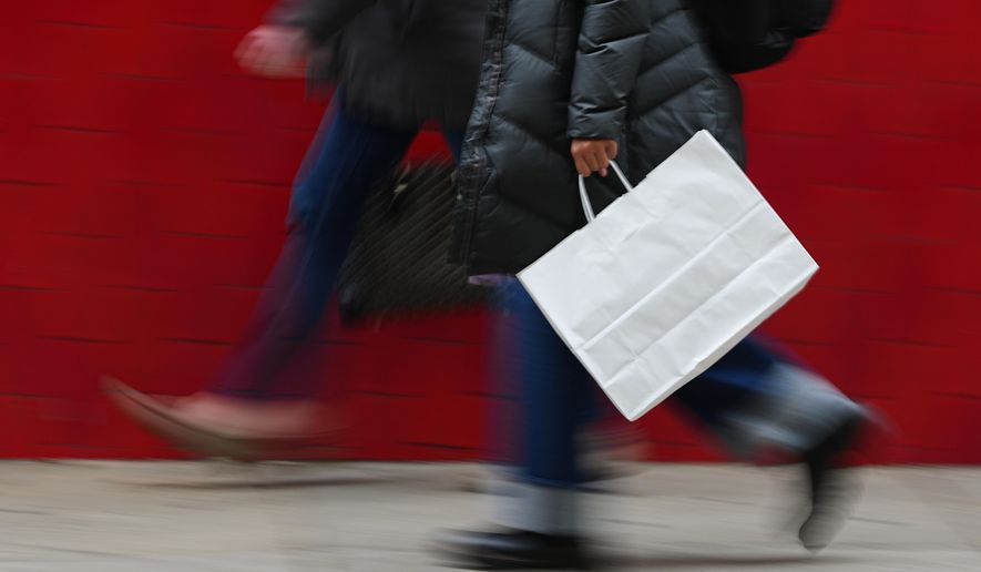 A person carries a shopping bag in Philadelphia, Dec. 10, 2025. (AP Photo/Matt Rourke, File)