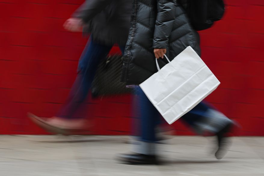 A person carries a shopping bag in Philadelphia, Dec. 10, 2025. (AP Photo/Matt Rourke, File)