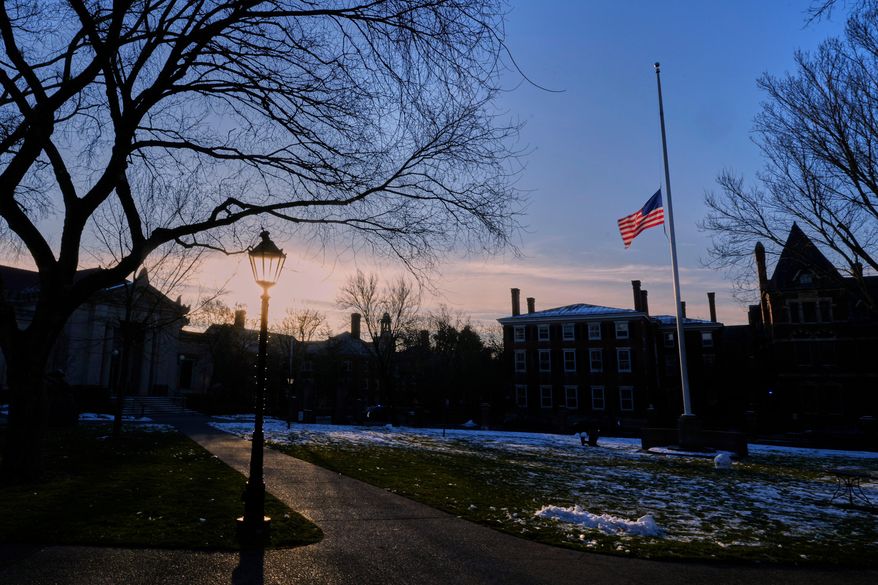 The U.S. flag flies at half-staff on the Main Green in honor of the victims of the campus shooting at Brown University, Wednesday, Dec. 17, 2025, in Providence, R.I. (AP Photo/Robert F. Bukaty)