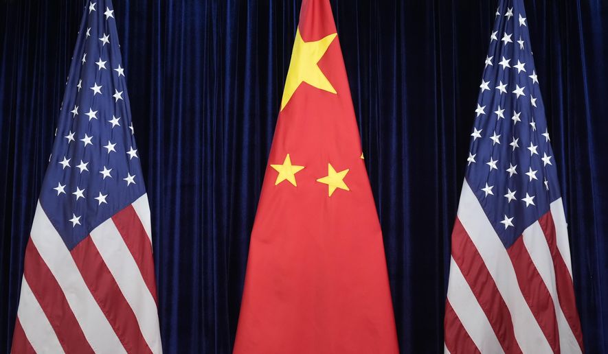 Flags of the U.S. and China are displayed at the Gimhae International Airport in Busan, South Korea, Oct. 30, 2025. (AP Photo/Mark Schiefelbein, file)