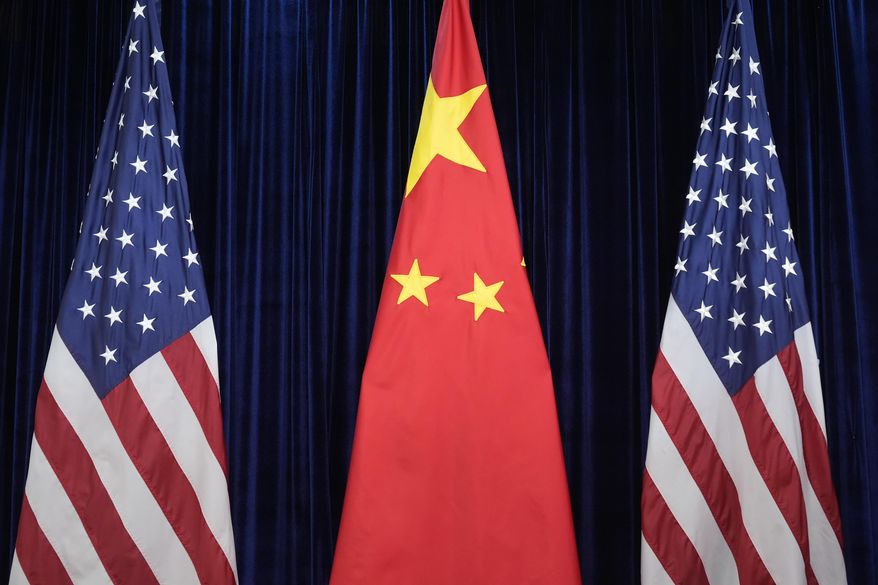 Flags of the U.S. and China are displayed at the Gimhae International Airport in Busan, South Korea, Oct. 30, 2025. (AP Photo/Mark Schiefelbein, file)