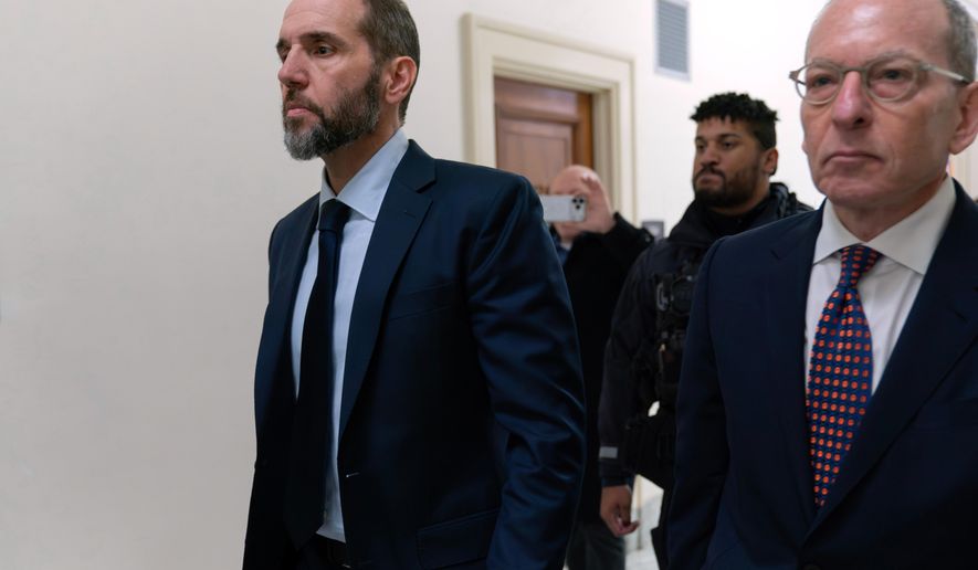Former Department of Justice Special Counsel Jack Smith, left, accompanied by his attorney Lanny Breuer arrive for a closed-door interview with House Republicans at Capitol Hill, Wednesday, Dec. 17, 2025, in Washington. (AP Photo/Jose Luis Magana)