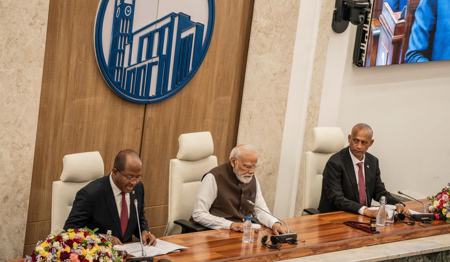 Indian Prime Minister Narendra Modi, center, sits between Ethiopia's House of People's Representatives Speaker Tagesse Chafo, left, and House of Federation Speaker Agegnehu Teshager during a visit at the parliament in Addis Ababa, Ethiopia, Wednesday, Dec. 17, 2025. (AP Photo/ Amanuel Sileshi)