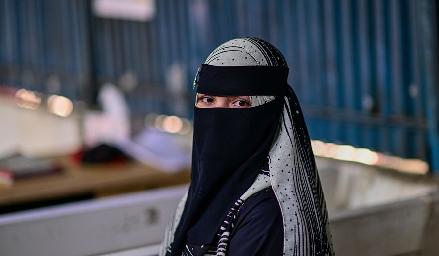 Hasina, a Rohingya refugee girl, sits inside the Rohingya refugee camp in Cox's Bazar, Bangladesh, Thursday, Nov. 20, 2025. (AP Photo/Mahmud Hossain Opu)