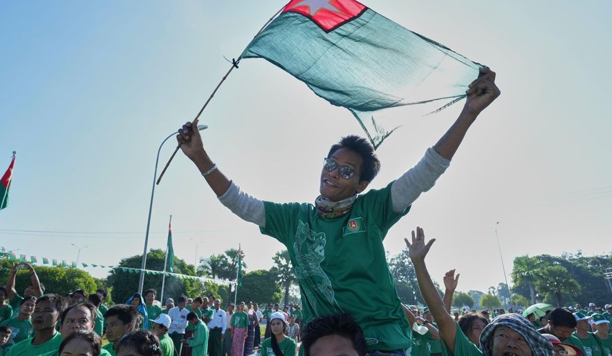 Supporters of the military-backed Union Solidarity and Development Party (USDP) wave the party flags during the first day of campaign for the upcoming general election, in Naypyitaw, Myanmar, Tuesday, Oct. 28, 2025.(AP Photo/Aung Shine Oo, File)